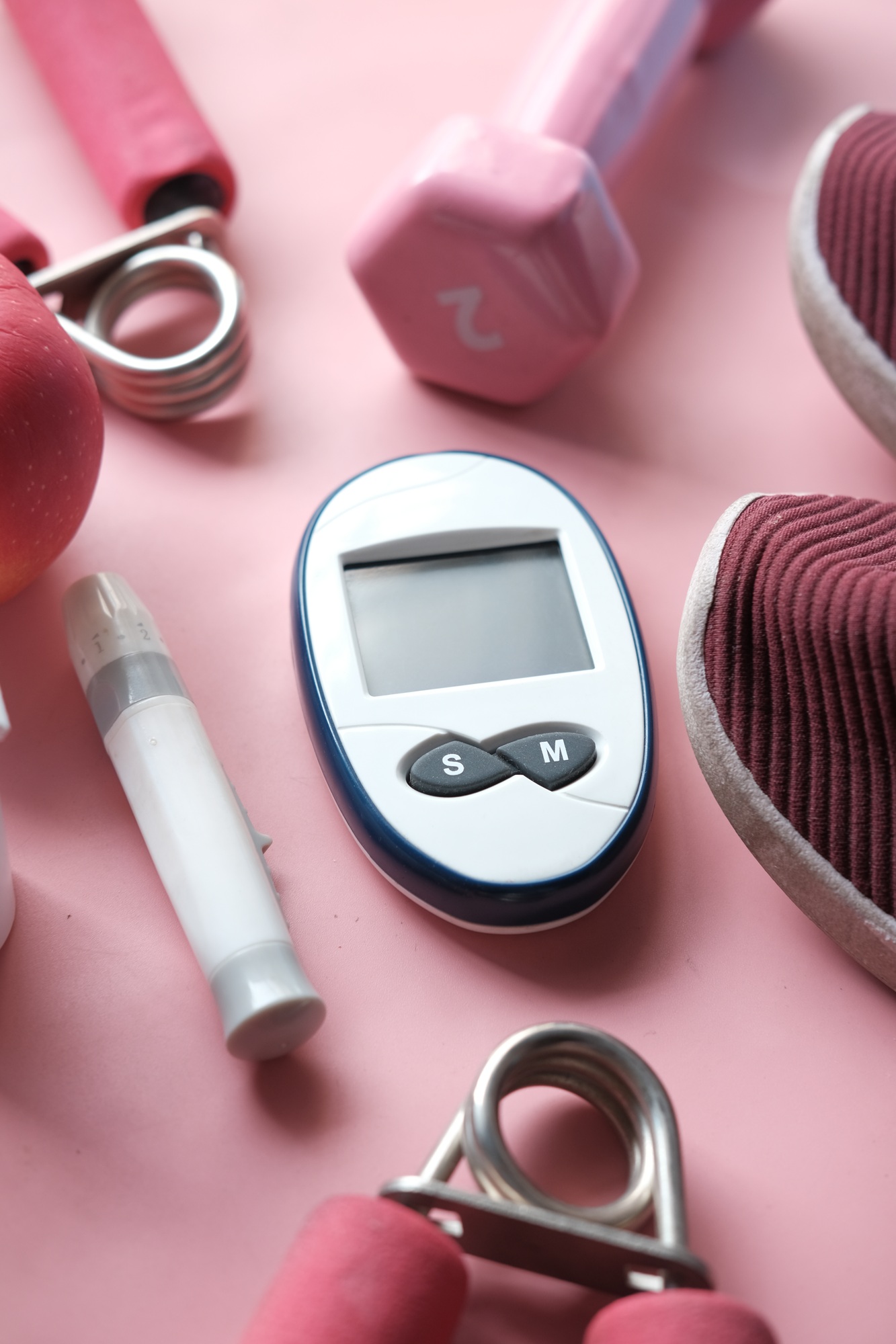 diabetic measurement tools, shoe and apple on table